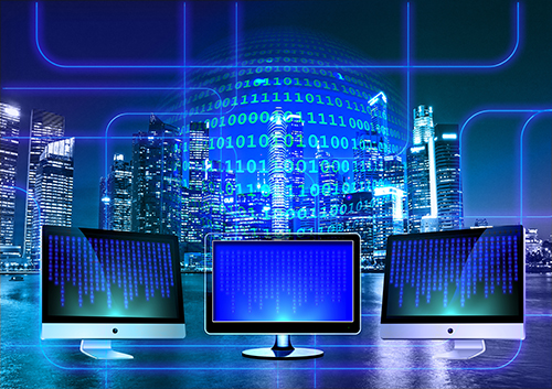 three computer screens with code with futuristic city background